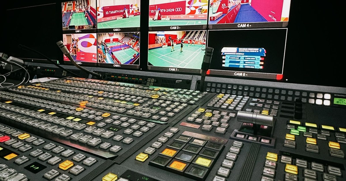 A television gallery vision mixer with banks of monitors showing live programme feeds